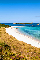 Pentle Bay with a sailing dinghy, Tresco, Isles of Scilly, UK. June 2015.