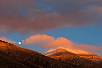 Moon rising over Mount Velino at sunset, in the Sirente-Velino Nature Reserve. Central Apennines, Abruzzo, Italy.