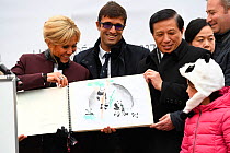 Naming ceremony of the 4-month-old panda cub at Beauval ZooParc on December 4, 2017 in St-Aignan, France. Chinese vice-foreign minister Zhang Yesui offering to Brigitte Macron, wife of the French pres...