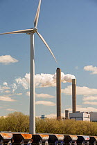 Wind turbine with stacks of coal fired power station in Amsterdam, Netherlands. May 2013