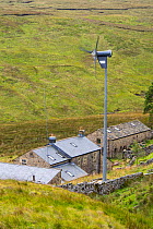 Remote off grid farmhouse at the head of Littondale with a wind turbine for power, Yorkshire Dales, UK. August 2014