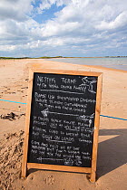 A sign about a nesting colony of Arctic and Little Terns near Low Newton, Norhumberland, UK. July 2014