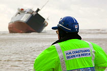 Coast guard looking at the 'Riverdance' washed ashore off Blackpool.  The 'Riverdance' was one of 3 ships lost in one day off the coast of the UK. The ship was hit by a huge wave that shifted the vehi...