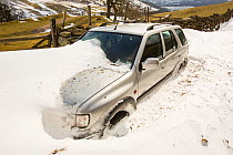 Four by four abandoned in massive snow drifts blocking the Kirkstone Pass road above Ambleside, Lake District, England, UK March 2013