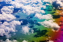 Cumulo Nimbus cloud and rainbow seen from an aeroplane window over the Argentinian coast. Argentina. February 2014