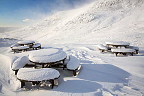 Picnic tables on the summit of Kirkstone Pass, plastered in fresh snow after overnight snow storms in the Lake District, Cumbria, UK.  January 2016