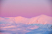 The Kentmere fells covered in snow at sunset, from Wansfell, Lake District, England, UK. January 2010