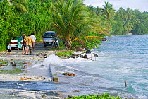 Tuvaluans watching as the high tide inundates their island home on Funafuti Atoll, Tuvalu. These low lying islands are very susceptible to sea level rise, March 2007