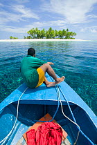 Man in boat in Funafuti Atoll, Tuvalu. MArch 2007. This area is low lying and very susceptable to sea level rise.