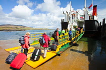 Foot passengers embark the Caledonian Macbrayne ferry, Loch Nevis, which services the Isle of Eigg from Mallaig, Scotland, UK.. May 2012