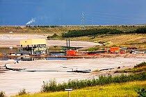 Tailings pond at the Syncrude mine north of Fort McMurray, Alberta, Canada. Tailings ponds in the tar sands are unlined and leach toxic chemicals into the surrounding environment.  August 2012