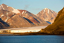 Glacier at Recherchefjorden on Western Svalbard with a mine supply ship. Svalbard, Norway. July 2013