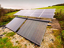 Solar photo voltaic panels and solar thermal panels providing electricity and hot water for a 16th Century farm house on Bodmin moor, Cornwall, UK. November 2012