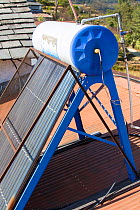 Solar thermal panels for heating water on the rooftops of a tea house in the Himalayan foothills, Nepal. December 2012