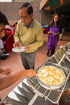 A solar cooker being used to cook food at the offices of WWF India, in Delhi, India. December 2013