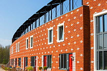 Houses in Almere with solar PV panels on the roof. It is the Netherlands youngest town, in Flevoland, which was reclaimed from the sea. This planned city is very green, with space heating provided fro...