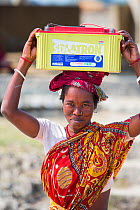 Woman collecting solar charged batteries from  WWF project to supply electricity to a remote island in the Sunderbans, Ganges Delta, India. December 2013