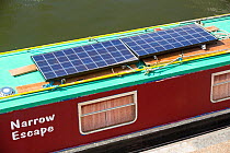 Solar panels on a canal boat behind Kings Cross, London, UK. June 2014