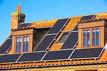 Solar panels on a house in Cley on the North Norfolk coast, UK. October 2014