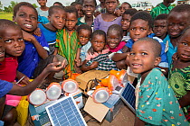 Children displaced by the January 2015 flooding with solar lights in Chiteskesa refugee camp after  near Mulanje. March 2015