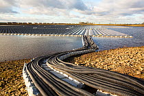 Floating solar farm being grid connected on Godley Reservoir in Hyde, Manchester, England, UK. February 2016