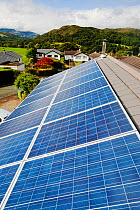 Solar voltaic panels on a house roof in Ambleside, Cumbria, UK. September 2011