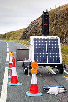 Set of traffic lights at road works, that are powered by a solar panel on Shap Summit, Lake district, England, UK. August 2010