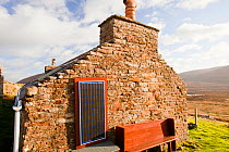 An old croft house with a solar panel at Rackwick on the isle of Hoy, Orkney, Scotland, UK. October 2011