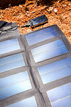 A portable solar mat used fro recharging a mobile phone in the Anti Atlas mountains of Morocco, North Africa. April 2012