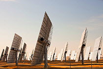 Heliostats, large reflective mirrors directing sunlight to the PS20 solar thermal tower, the only such working solar tower currently in the world. Sanlucar La Mayor, Andalucia, Spain. May 2011