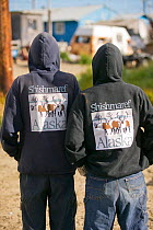Inuit people in hoodies with the name of the island 'Shishmaref'. Alaska, USA. September 2004