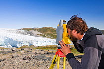 Scientist taking measurements as part of a study to measure the speed of the Russelll Glacier near Kangerlussuag Greenland, July 2008