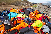 Life jackets and remains of boats left by Syrian migrants, refugees fleeing the war. Lesvos Island, Efthalou, Greece. September.