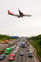 Traffic congestion on the M1 motorway at Loughborough,  with a plane coming into land at East Midlands Airport. August 2005