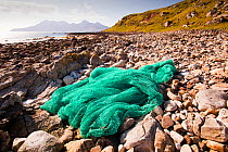 Fishing net washed up at the singing sands on the west coast of the Isle of Eigg, Scotland, UK. May 2012