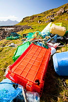 Plastic rubbish washed up at the singing sands on the west coast of the Isle of Eigg, Scotland, UK. May 2012