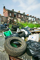 Illegal fly tipping in a rundown area of Blackburn, England, UK. June 2006