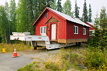 House in Fairbanks Alaska moved after it started collapsing into the ground due to global warming induced permafrost melt. August 2004