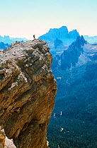 A mountaineer on a summit in the Italian Dolomites. Italy.