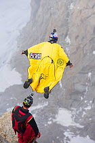 Base jumpers wearing wing suites jumping from the Aiguille Du midi above Chamonix, France. September 2014