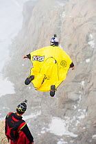 Base jumpers wearing wing suites jumping from the Aiguille Du midi above Chamonix, France. September 2014