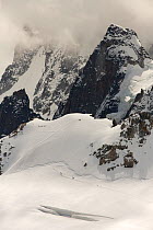 Mont Blanc Du Tacul,  with mountaineers crossing the Vallee Blanche.  Aiguille Du midi, above Chamonix, France, September 2014