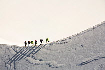 Climbers on the arete leading up from the Vallee Blanche to the Aiguille Du Midi above Chamonix, France. September 2014