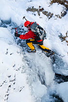Mountaineer, Mike Withers ice climbing in Fisher Place gill above Thilrmere, Lake District, UK. This waterfall very rarely comes into climbable condition, but did in January 2010.