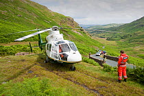 Paramedics from the Great north Air Ambulance and members of Langdale/Ambleside Mountain Rescue  evacuate an injured man who fell into Wrynose Beck. England, UK. July 2009