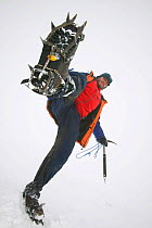 Low angle view of climber with crampons on boot, Aonach Mhor, Scotland, UK.  March 2004