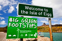 Big green Footsteps sign on Eigg Harbour, Scotland, UK. May 2012
