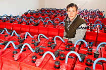 Crofter and Eigg Electric employee amongst the array of backup batteries that store sufficient to power the island for 24 hours.  Isle of Eigg is powered by renewable energy and backup batteries store...