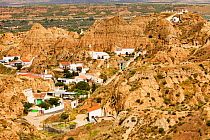 Old Cave houses in Guadix, Andalucia, Spain. Up to 10,000 people still live in cool underground houses dug out of the rock, this area known as the Barrio Santiago is a mix of modern cave houses and an...