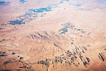 Aerial view showing desert landscape and irrigated fields, Iran, March 2009.